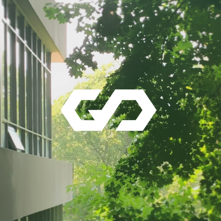 GP's logo overlayed on a photo of tree leaves